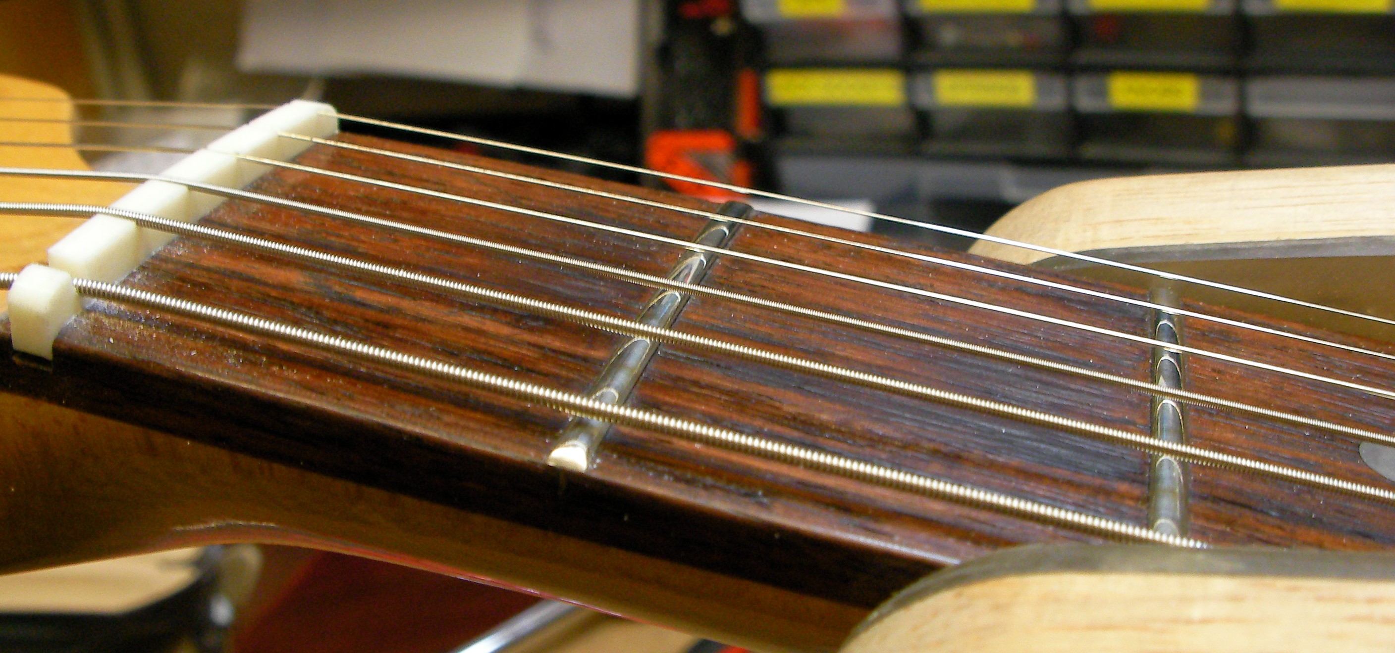 Bass guitar nut slots